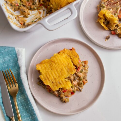 plated plantain shepherd's pie next to a casserole dish containing more