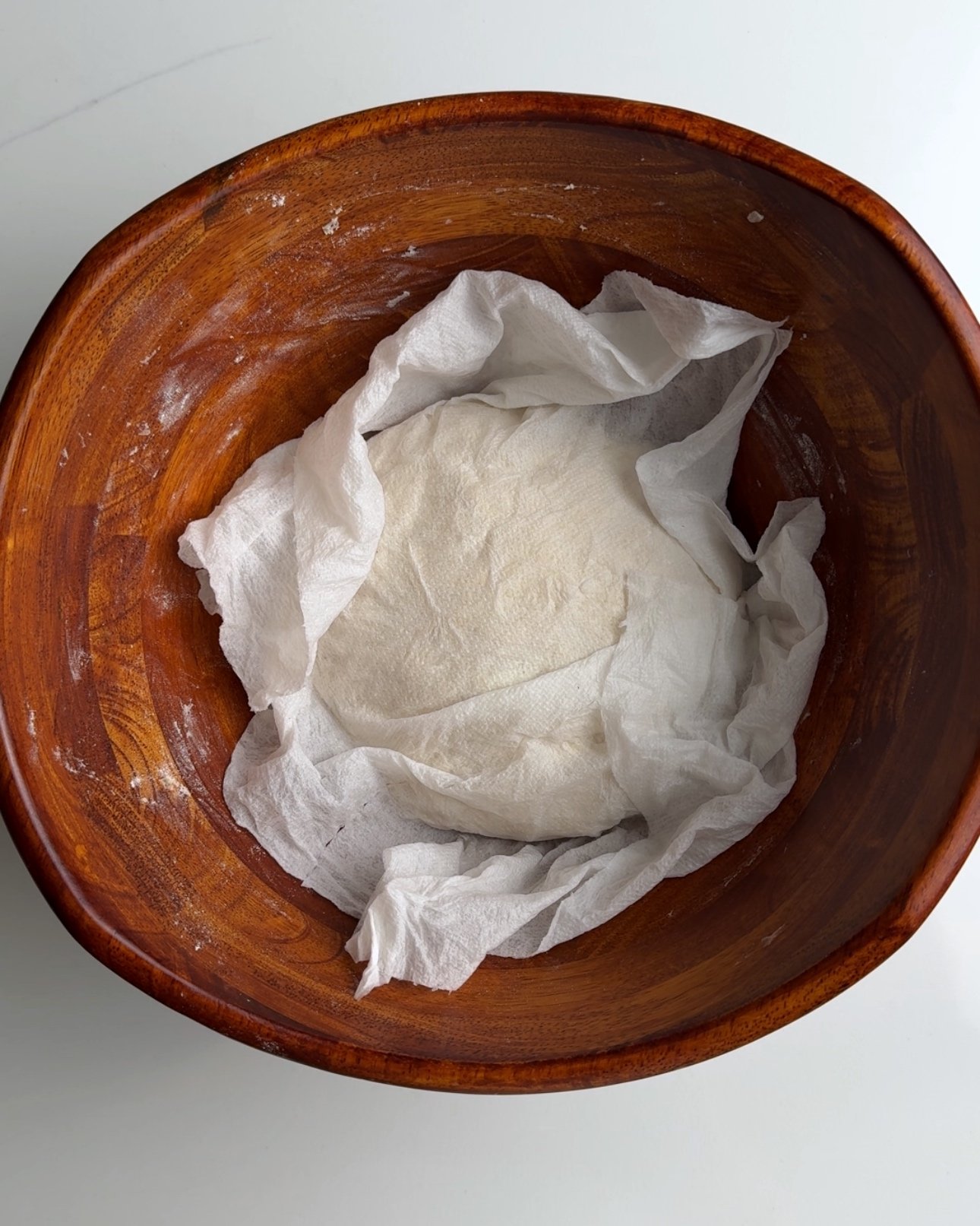 Bake in a wooden bowl resting with a paper towel over the dough