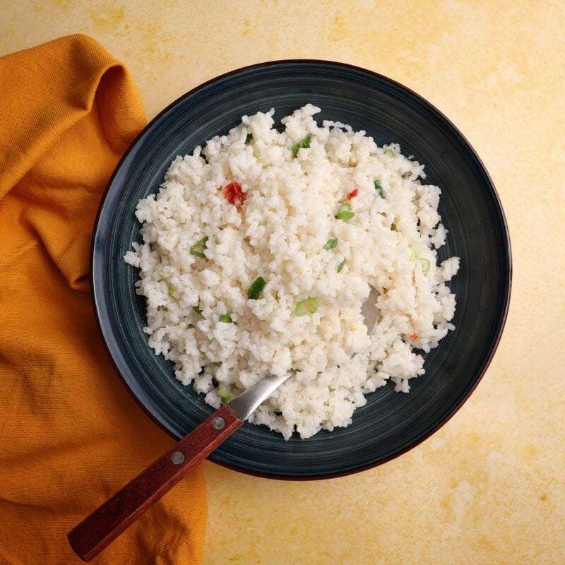 Guyanese shine rice in a blue bowl on a yellow back ground