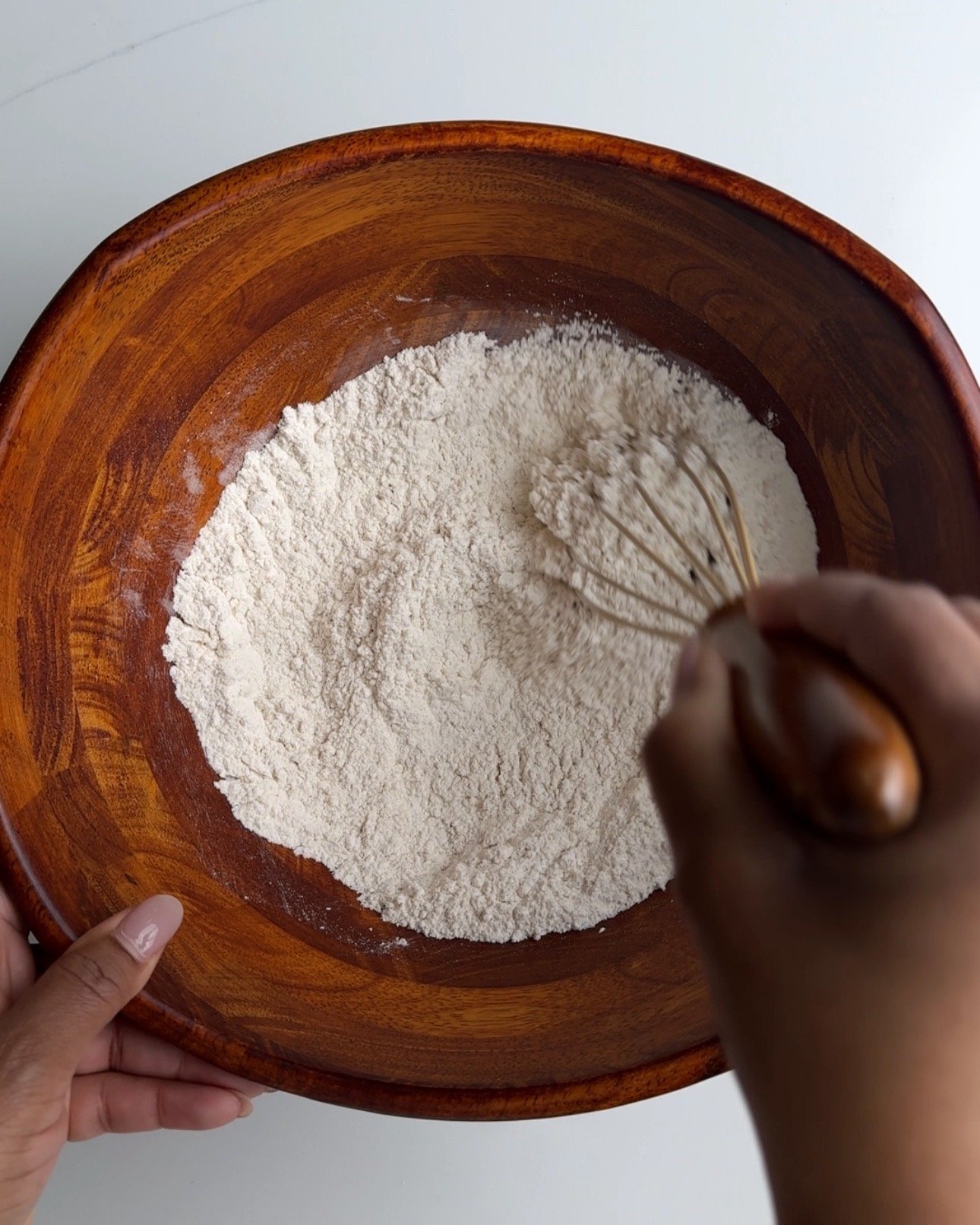 Mixing dry ingredients in a bowl with a whisk