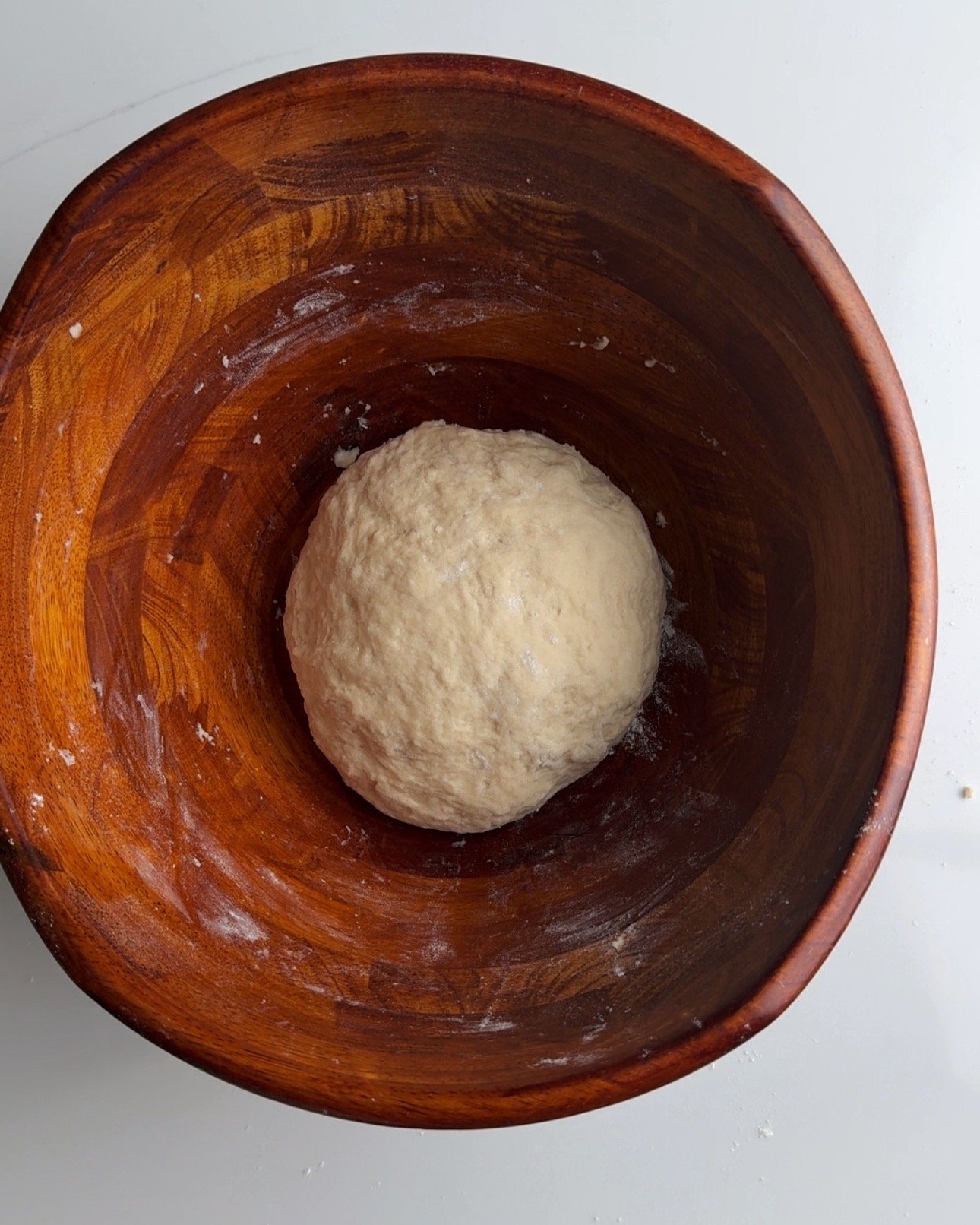resting the dough in a wooden bowl