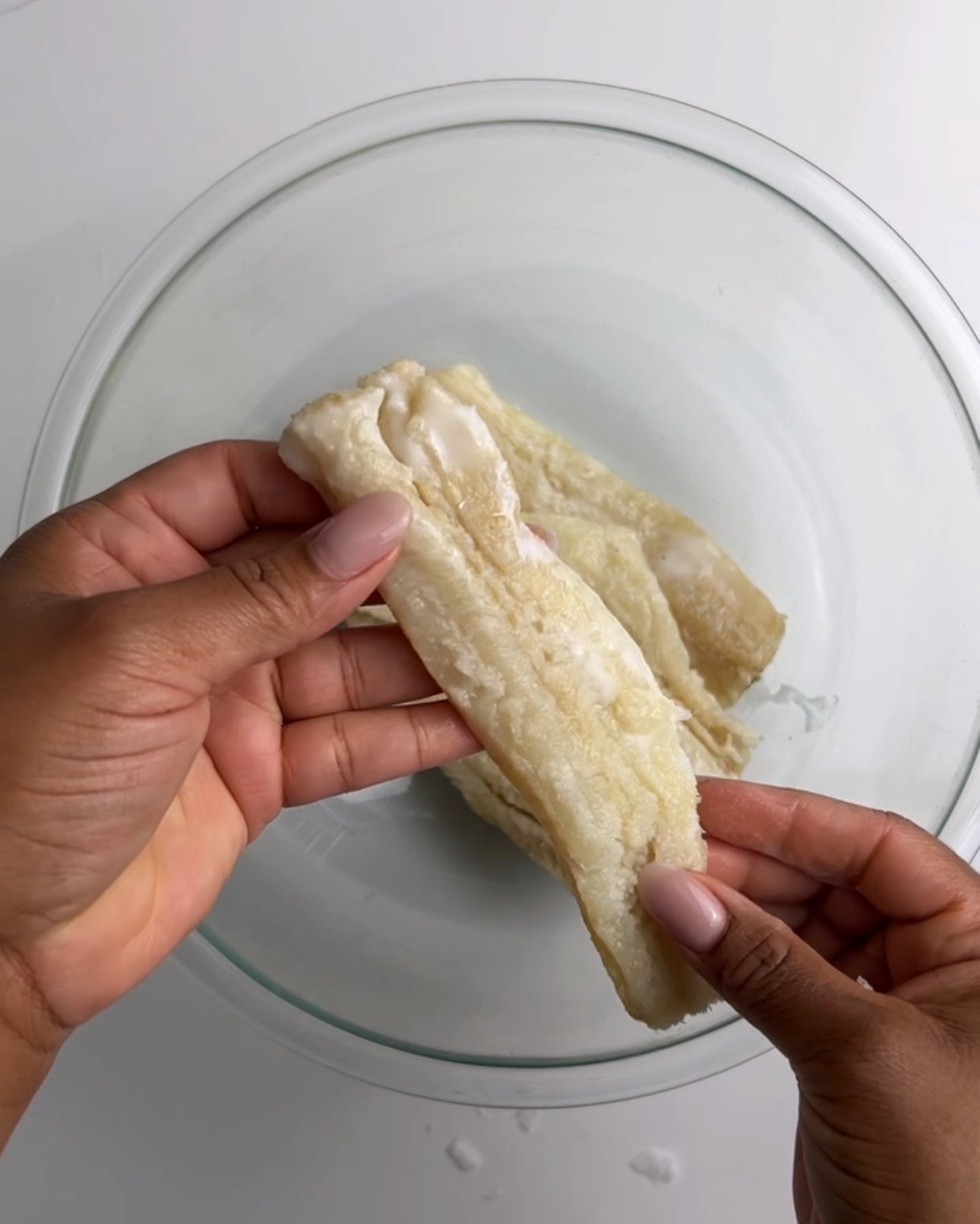 Holding a piece of saltfish to show the saltiness