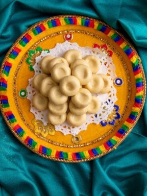 Guyanese peera on a multicolored dish on a teal saree