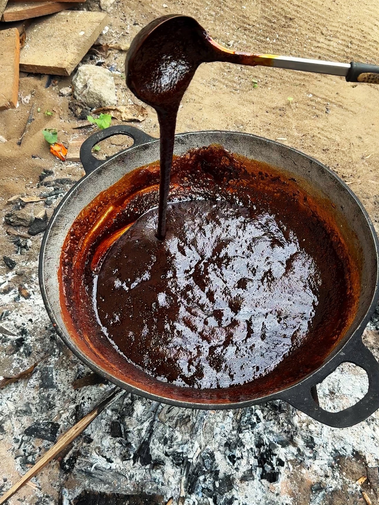 Thick, dark cassareep in a pot