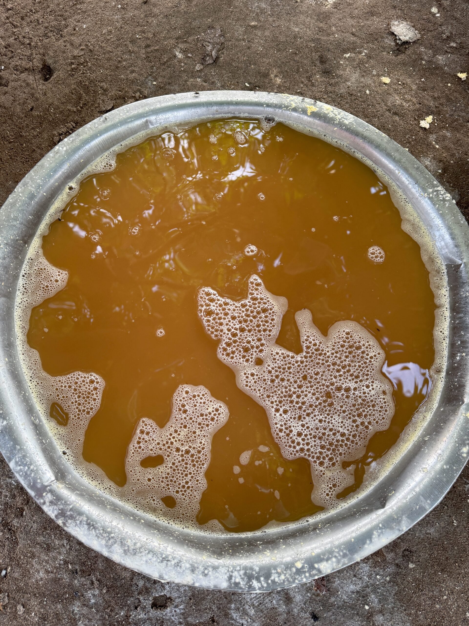 A bowl of cassava juice with tapioca settled to the bottom
