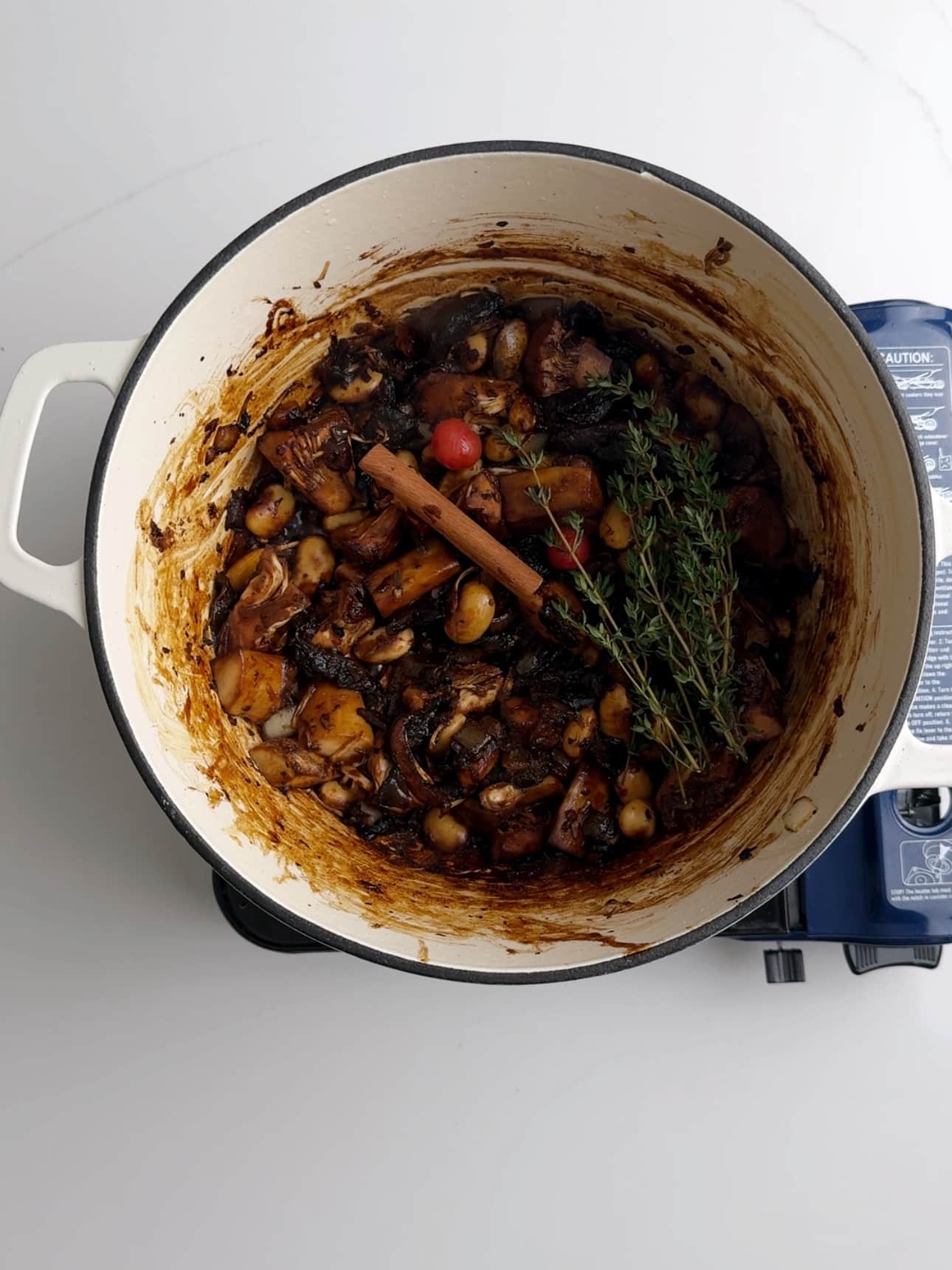 Vegan pepperpot simmering in a dutch oven.