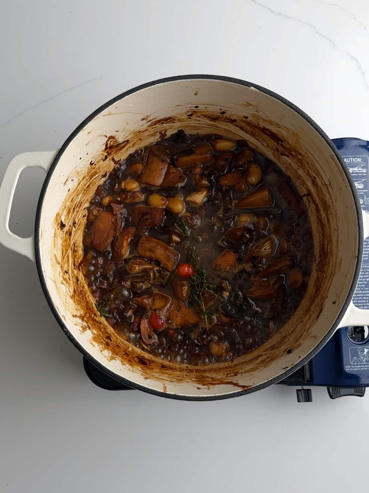 Vegan pepperpot simmering in a dutch oven.