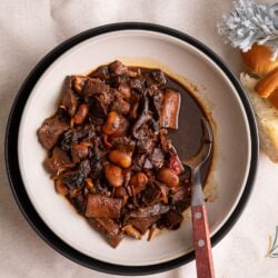 Pepperpot in a plate with a spoon to the right.