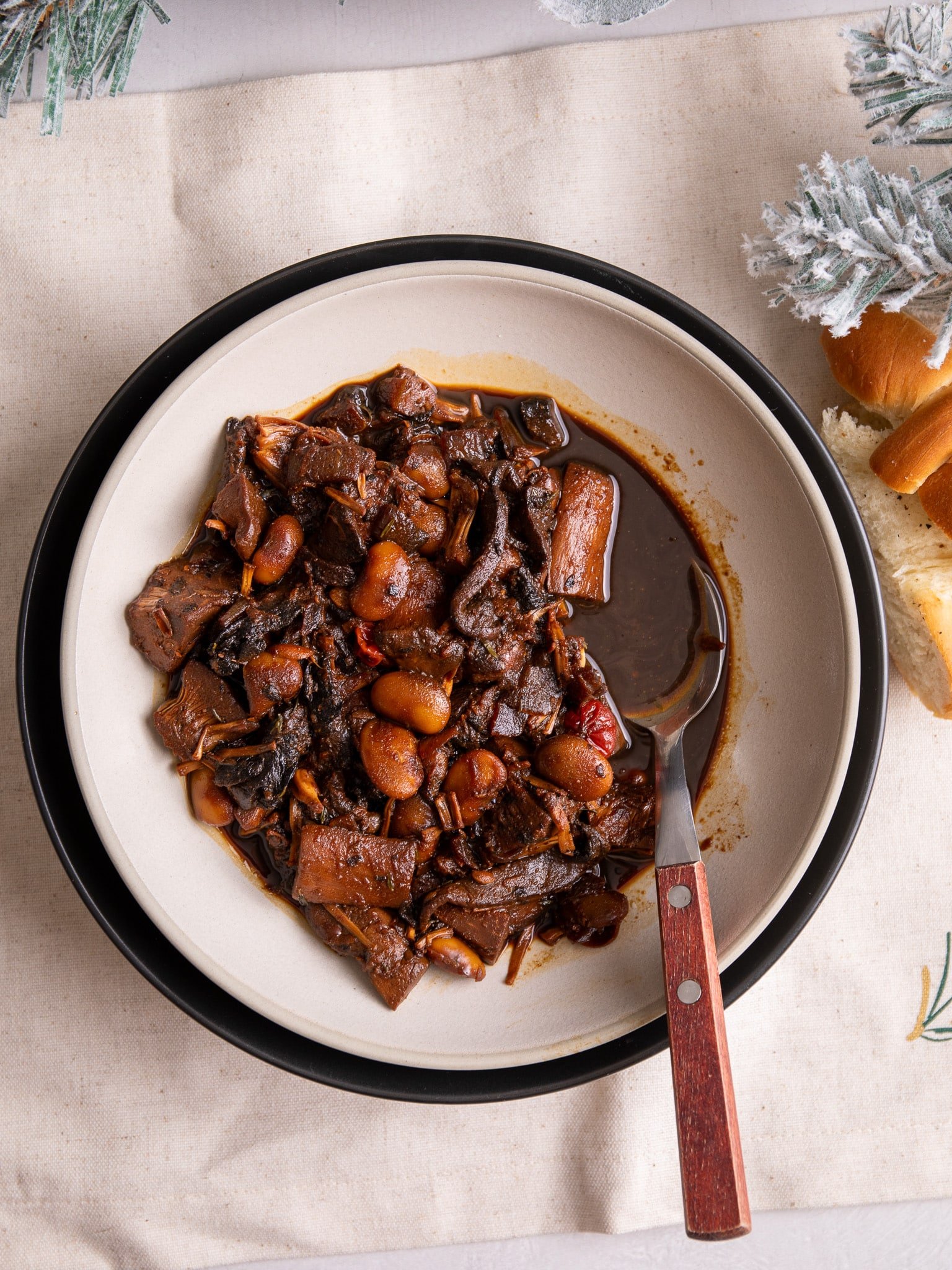 Pepperpot in a plate with a spoon to the right.