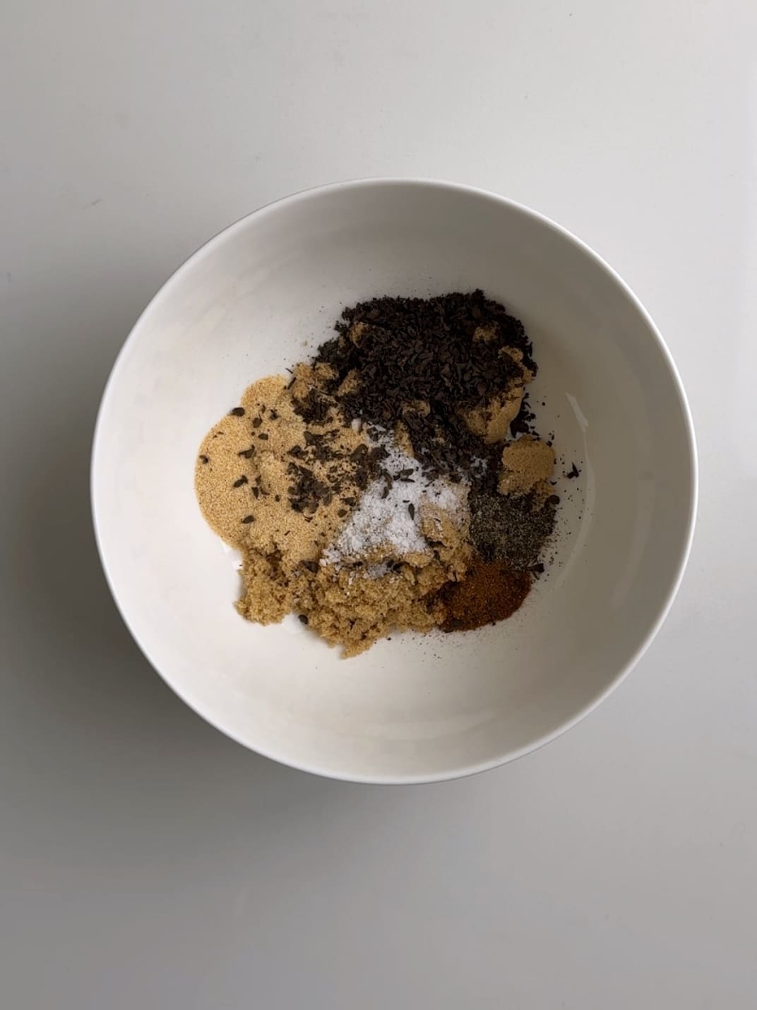 Dry ingredients for pepperpot in a white bowl