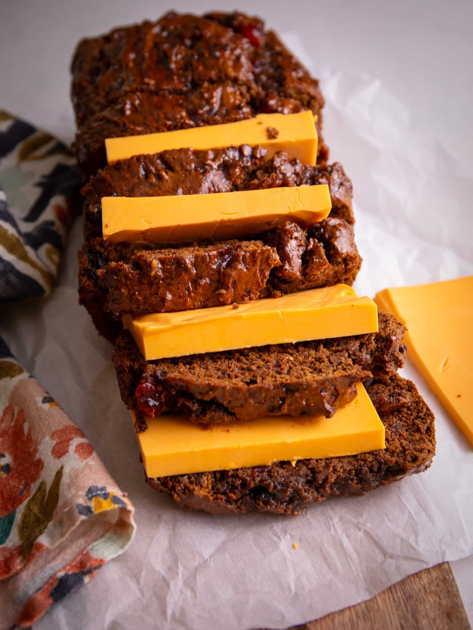 Sliced Jamaican Easter bun served with thick slices of cheese stacked between each piece.