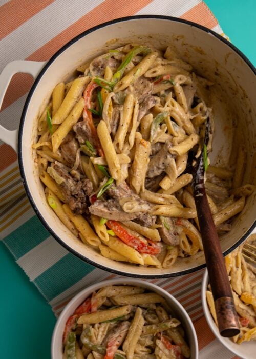 Jerk chicken pasta with penne in a creamy parmesan sauce with bell peppers and sliced chicken.
