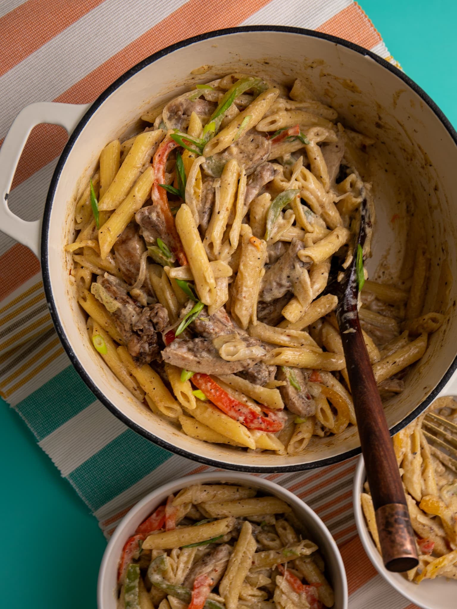 Jerk chicken pasta with penne in a creamy parmesan sauce with bell peppers and sliced chicken.