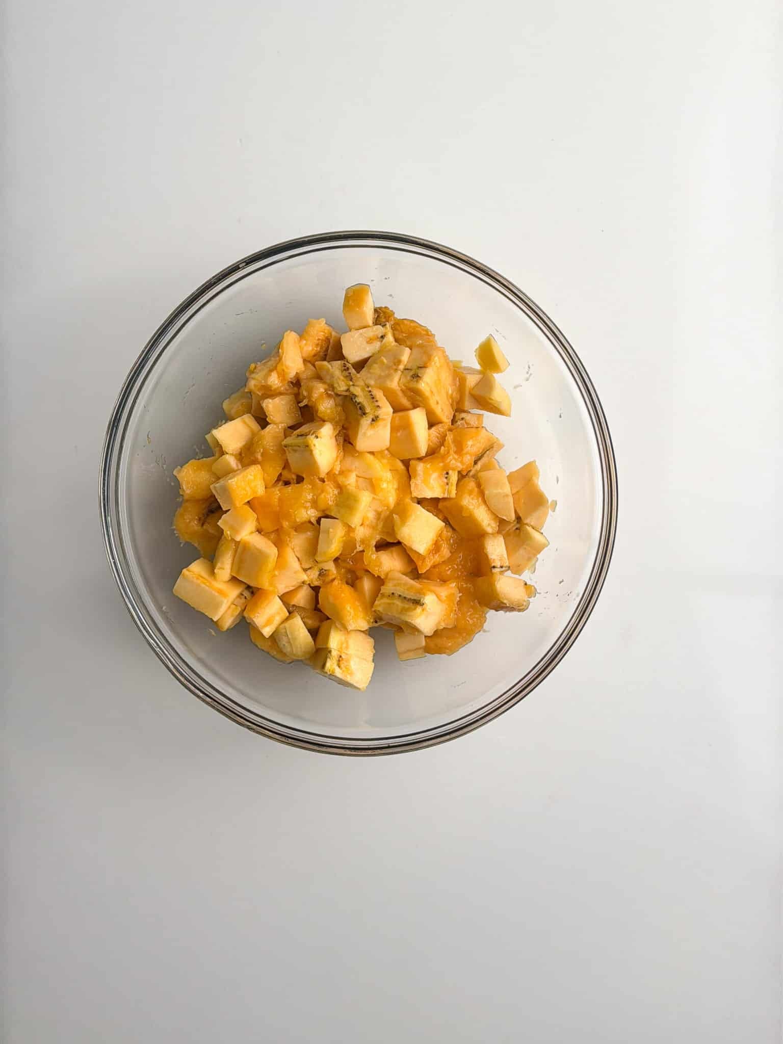 Diced ripe plantains in a glass bowl.