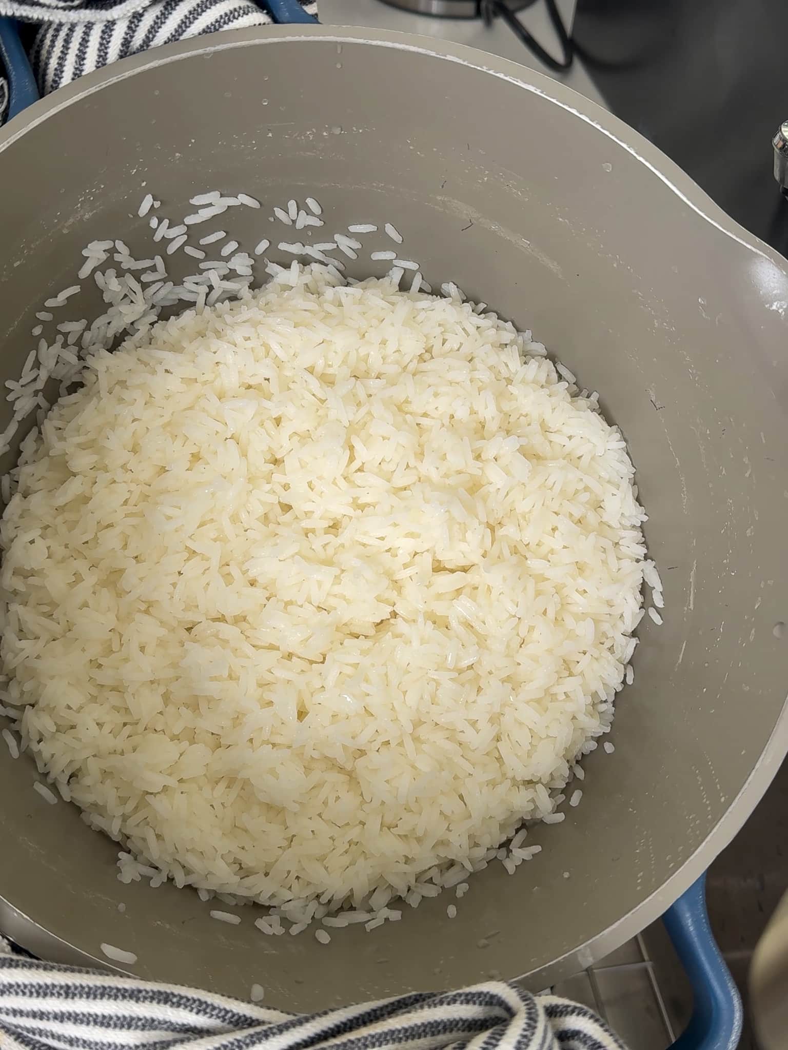 Fluffy cooked white rice after draining and steaming in the pot