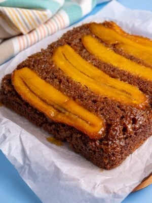 Angled close-up of caramelized plantain bread showing the moist texture and shiny plantain topping.
