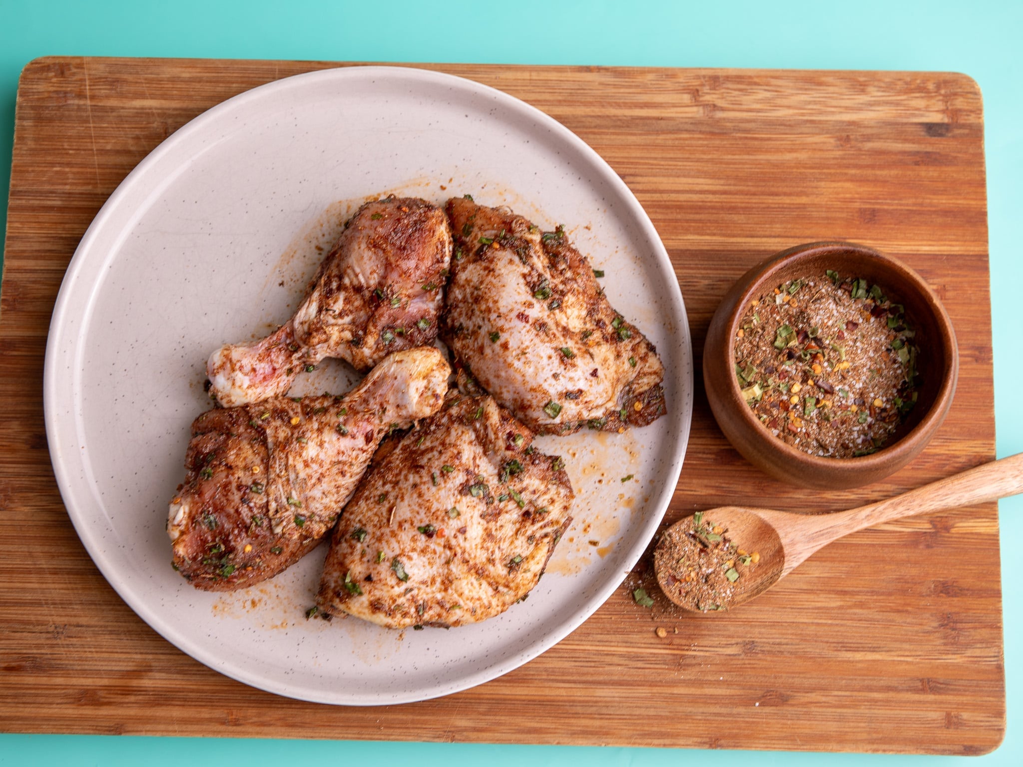 Chicken thighs and drumsticks coated with Jamaican jerk seasoning dry rub before baking