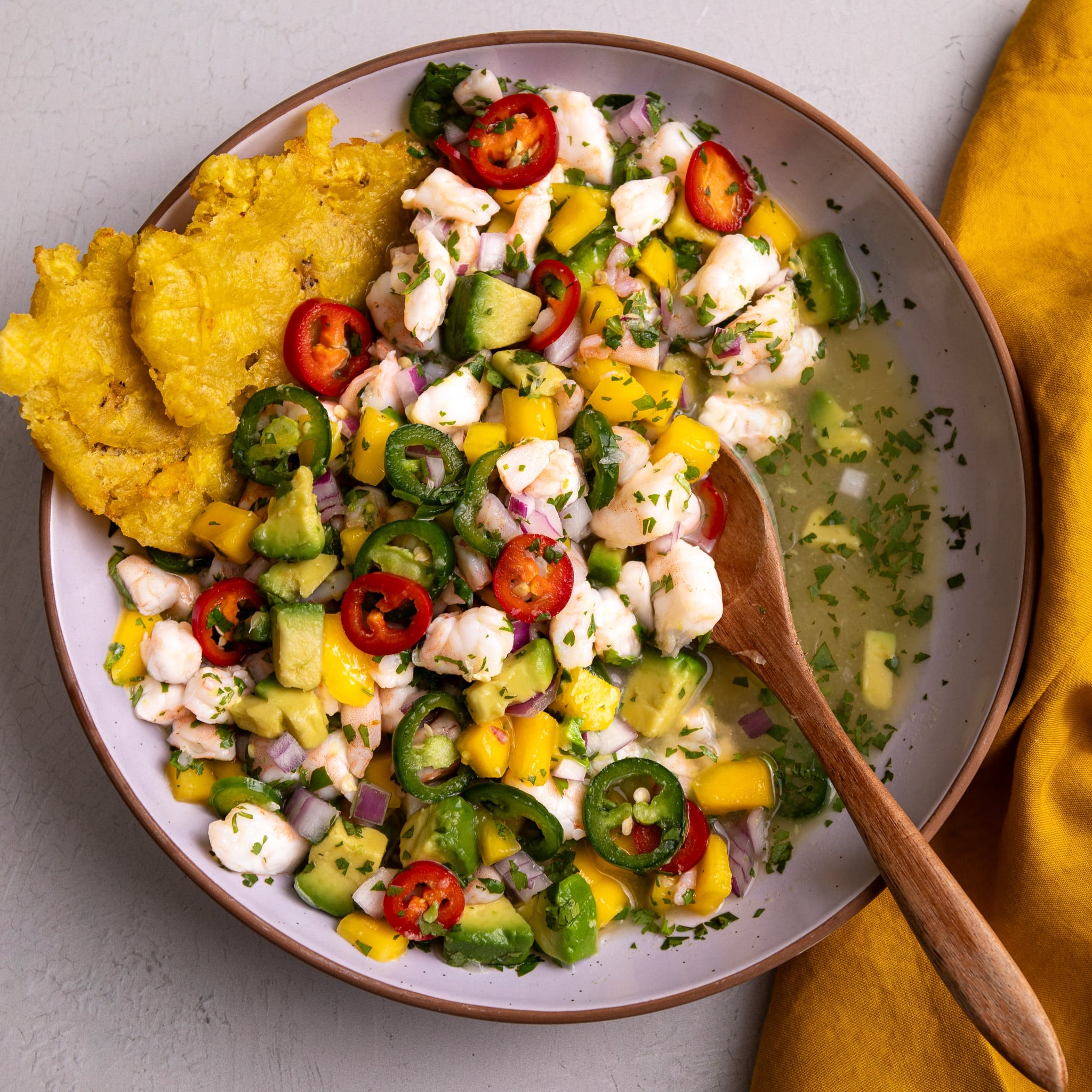 Tropical shrimp ceviche with mango and avocado served with crispy tostones